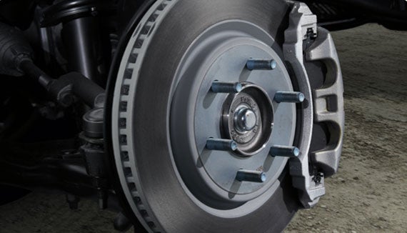 A new brake rotor and pad assembly being installed on a heavy-duty truck.