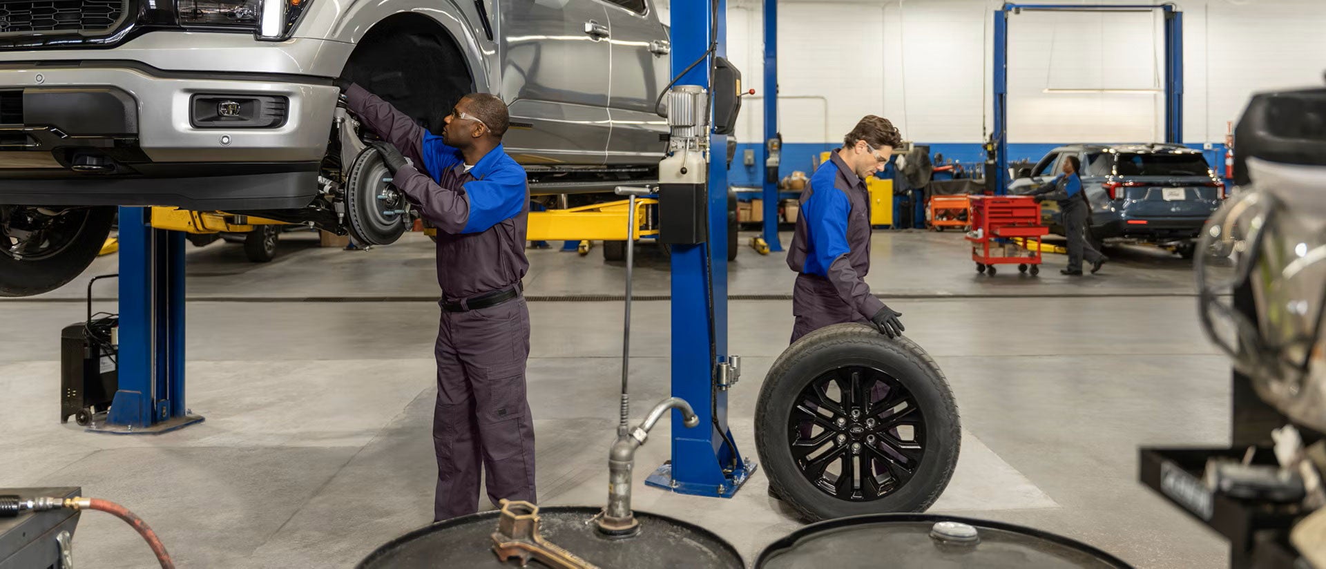 Fremont Ford Riverton service technicians inspecting tire wear