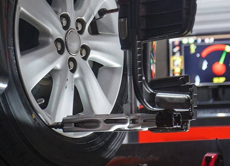 Precision computer wheel alignment service being performed on a vehicle rack at Fremont Ford Riverton